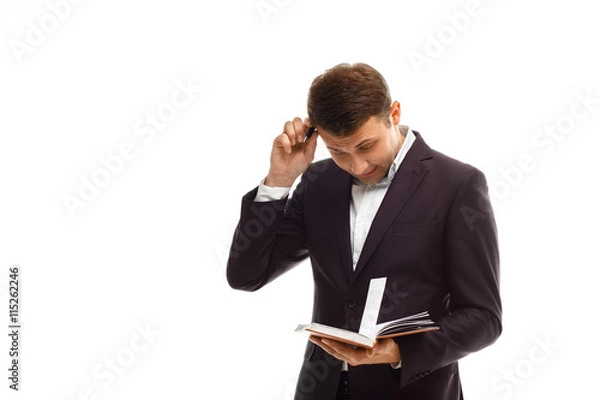 Obraz Handsome businessman with diary