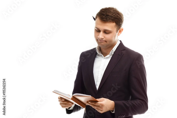 Obraz Handsome businessman with diary