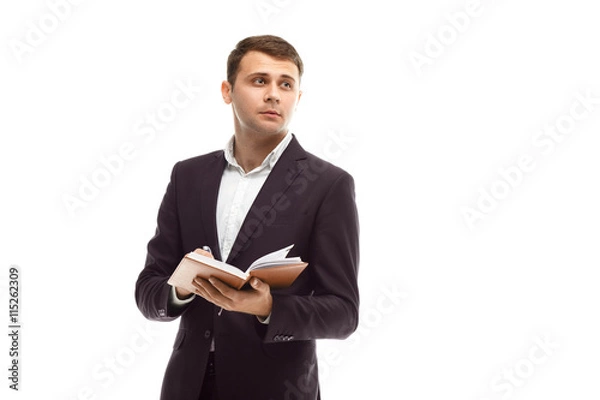 Obraz Handsome businessman with diary