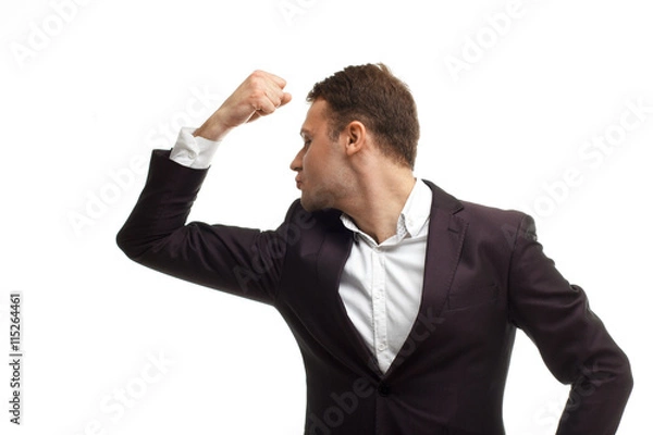 Obraz Handsome businessman shows biceps