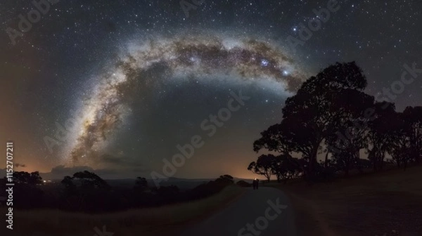 Fototapeta A photographer capturing the Milky Way with a long exposure shot in a remote area