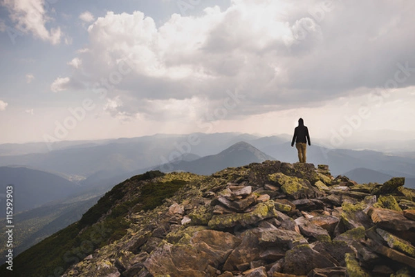 Fototapeta A man on a mountain top