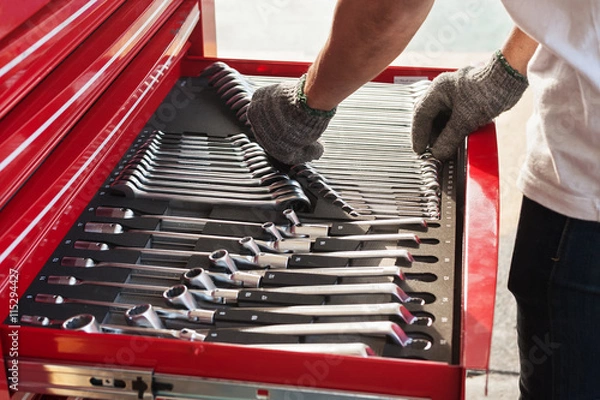 Obraz Hand picks a tool for car repair