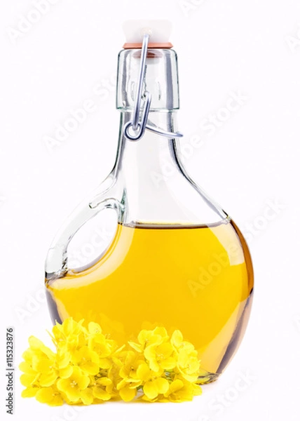 Obraz Extra virgin  oil in a bottle with rapeseed flowers