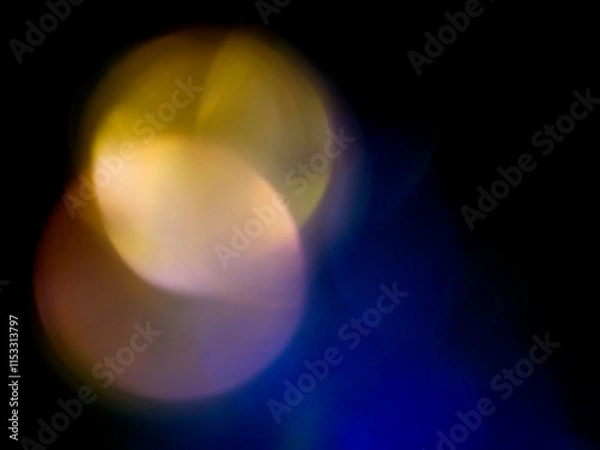 Fototapeta Abstract light leak effect on dark background for creating special effects. The colors are vibrant and the circles are overlapping, creating a sense of movement and energy. Abstract art.