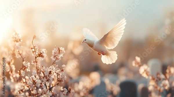 Fototapeta A white dove in flight, a symbol of peace and remembrance, soars over a tranquil graveyard bathed in gentle sunlight This image evokes feelings of tribute and spirituality, finding solace amidst