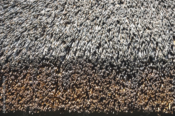 Fototapeta Close-up of an old straw thatched roof. Weathered thatched roof texture