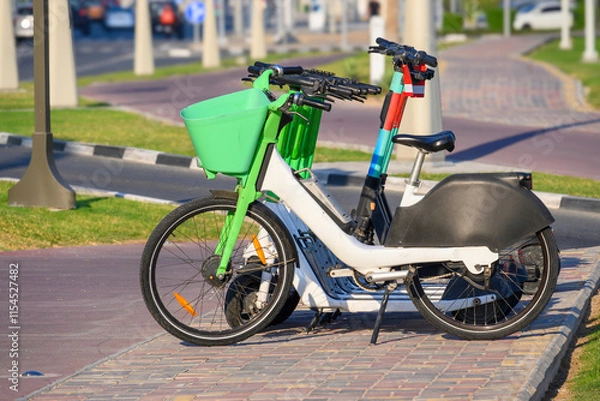 Obraz City bikes and scooters standing on the sidewalk in the city