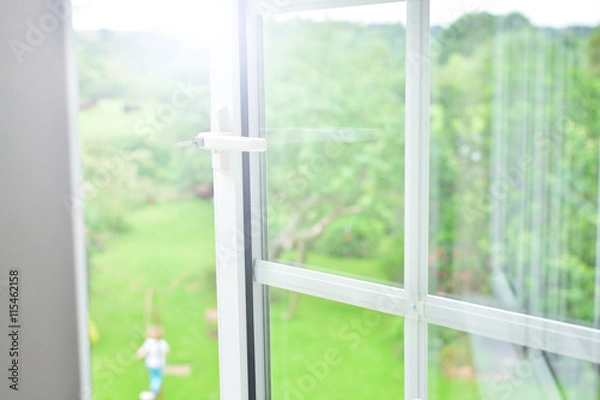 Fototapeta Window with view of summer backyard 