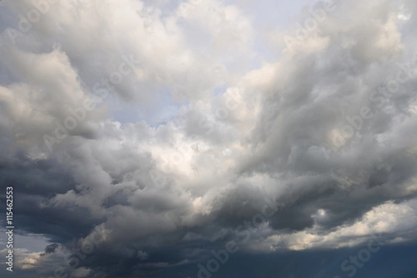 Fototapeta Heavy white and grey clouds gathering before rain