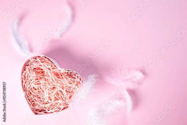 Fototapeta Heart-shaped gift box on a pink background with feathers . Layout for your product.High angle. Holidays, romance, Valentine's Day, Cosmetic products, perfume, 