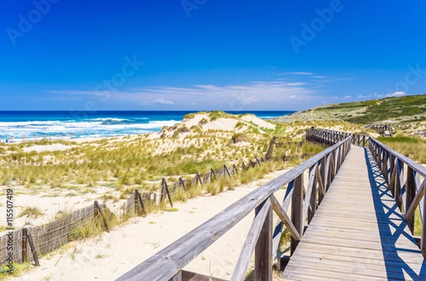 Fototapeta Foot bridge at Cala Mesquida - sand dunes at coast of island Mallorca, Spain