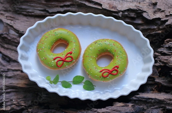 Fototapeta Donuts in a white plate on a wooden background