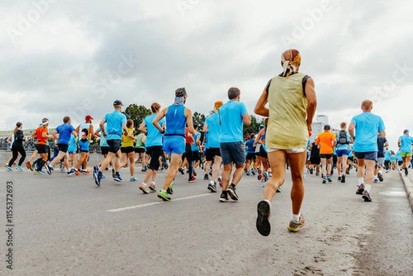Obraz rear view large group runners run started marathon race