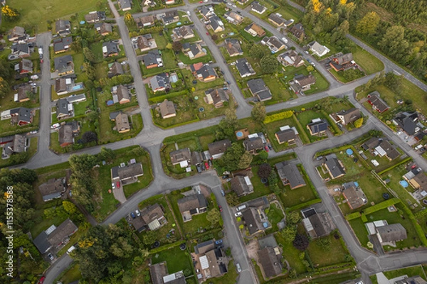 Fototapeta View of a small European town from a drone. Many private and residential houses. A cozy place to live with developed infrastructure.