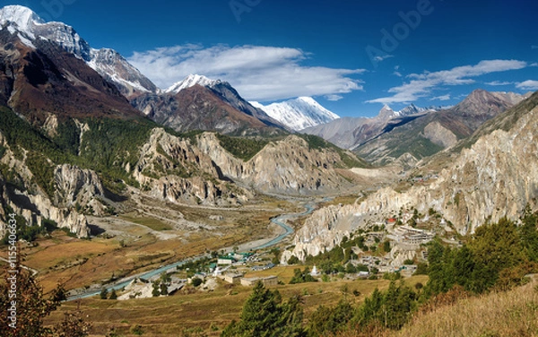Fototapeta Picturesque view of Marsyangdi River valley and Bhraka village, flowing along northern slopes of Annapurna mountain range. Himalayas, Nepal.