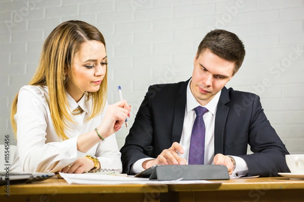 Obraz Two business people using tablet computer in office