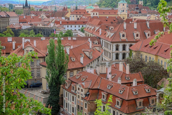 Fototapeta Prague city's rooftops and town, with traditional Baroque style buildings and architecture.