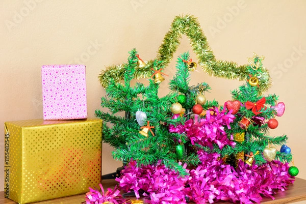Fototapeta Small Christmas Tree with Decorative line and Gift Boxes on Table