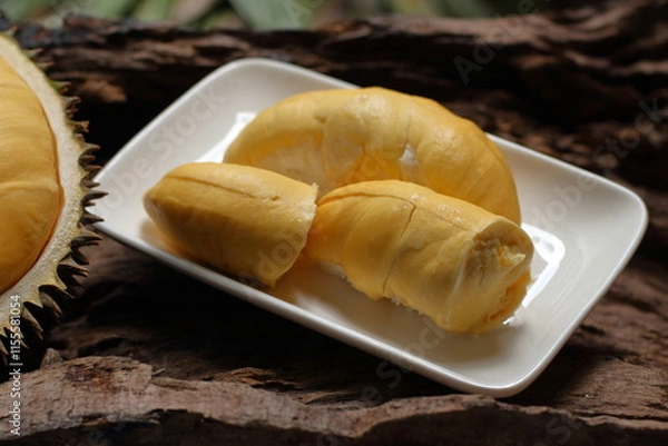 Fototapeta Durian in a white plate on a wooden background