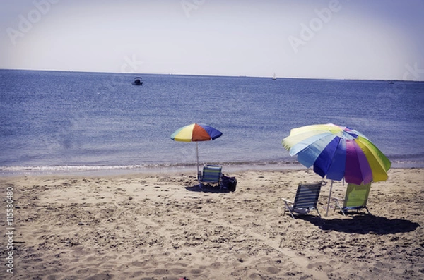 Fototapeta Beach umbrellas and chairs on a beach in Eastham, MA Cape Cod.