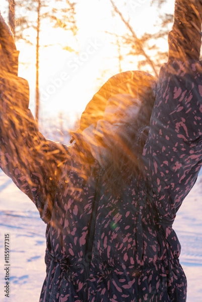 Obraz Young woman throwing snow in the air at sunset. Shallow depth of field.