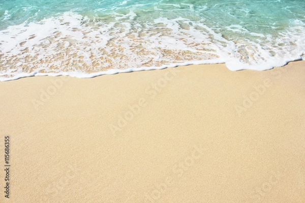 Fototapeta Soft wave of blue ocean on the sandy beach, background.