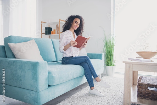 Fototapeta Full body portrait of nice young woman read book sofa free time modern interior flat indoors