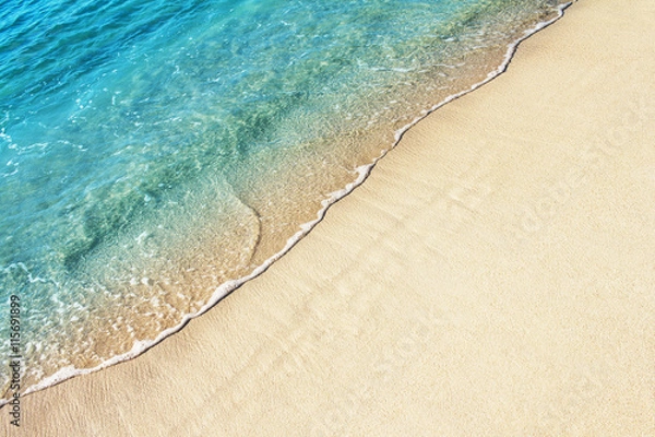 Fototapeta Soft ocean wave on the sandy beach, background.