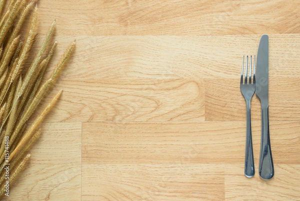 Fototapeta fork and knife on old wood with grass flower texture background