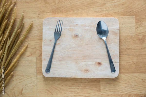 Fototapeta fork and spoon on old wood with grass flower texture background