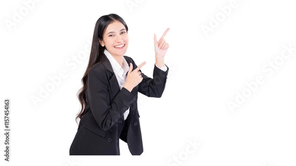 Fototapeta Happy young smiling professional business woman wearing black suit looking at camera pointing finger away at copy space showing aside presenting advertising offer studio shot