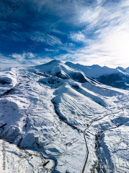 Fototapeta Beautiful aerial view of snowy peaks in a picturesque gorge. Landscape and nature of the North Caucasus