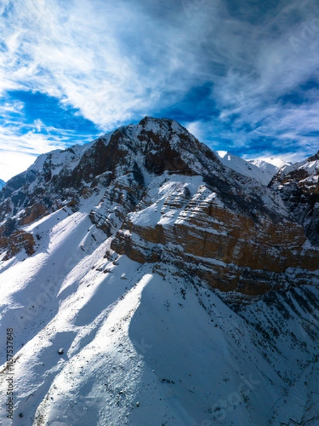 Fototapeta Beautiful aerial view of snowy peaks in a picturesque gorge. Landscape and nature of the North Caucasus