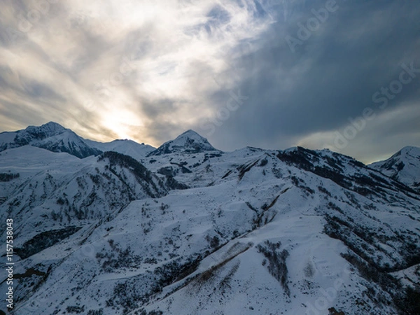 Fototapeta Beautiful aerial view of snowy peaks in a picturesque gorge. Landscape and nature of the North Caucasus