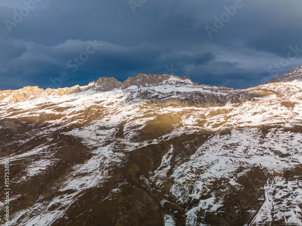 Fototapeta Beautiful aerial view of snowy peaks in a picturesque gorge. Landscape and nature of the North Caucasus