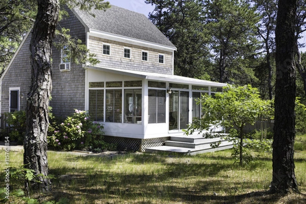 Fototapeta Salt box house in the forest in Wellfleet, MA on Cape Cod.