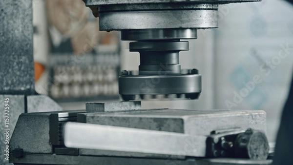 Obraz Close up of a powerful industrial stamping machine pressing a metal workpiece, showcasing the precision and force involved in metalworking processes within a factory or manufacturing setting