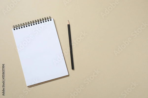 Fototapeta Top view photo of notebook with a pencil on color background with blank space. Business concept