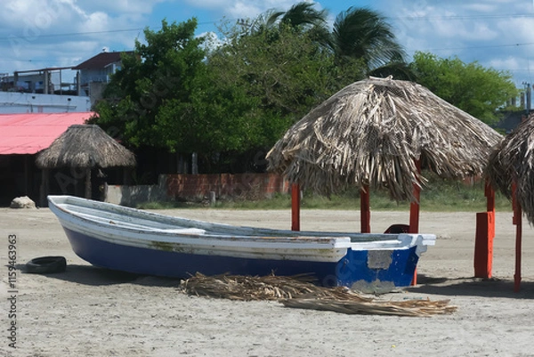 Obraz Panoramic view of a Caribbean setting with a rustic boat and a straw hut on the beach.