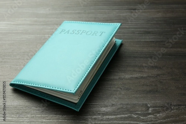 Fototapeta Passport in turquoise cover on wooden table, closeup