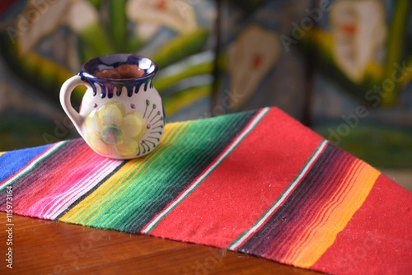 Obraz Empty wooden table over wood background with mexican coffee mug copy space