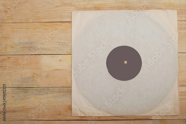Obraz Retro styled image of a collection of old vinyl record lp's with sleeves on a wooden background. Copy space. Top view