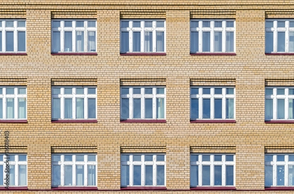 Fototapeta Brick facade of the house with white windows. Texture, background series