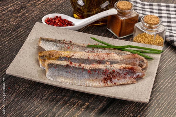 Obraz Salted marinated herring fillet with spices
