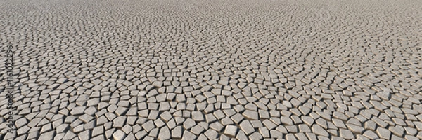 Fototapeta Irregular stone tiles forming geometric ground pattern
