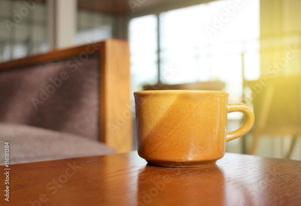 Fototapeta Coffee on wooden table with burst light