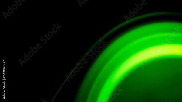 Obraz Green light trails creating abstract circular pattern on black background