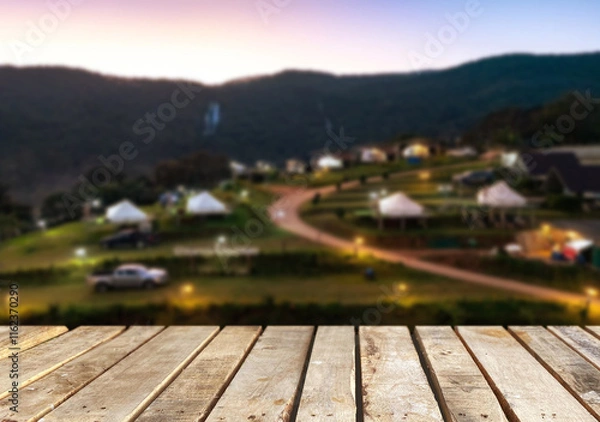Fototapeta Wooden table top on camping ground mountain and grass field.Fresh and Relax concept.For montage product display or design key visual layout.View of copy space.