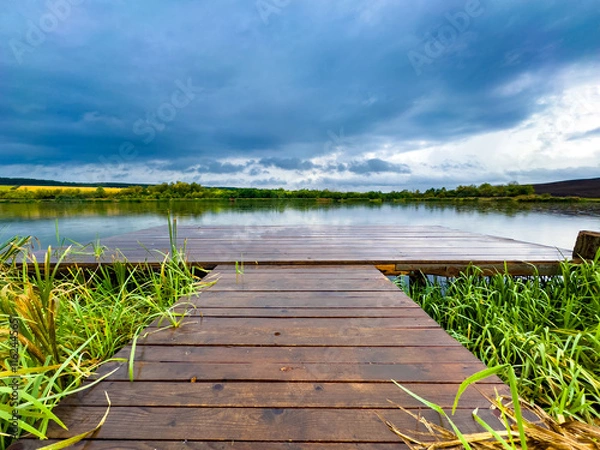 Obraz panorama with wooden pontoon overlooking the lake at sunset
